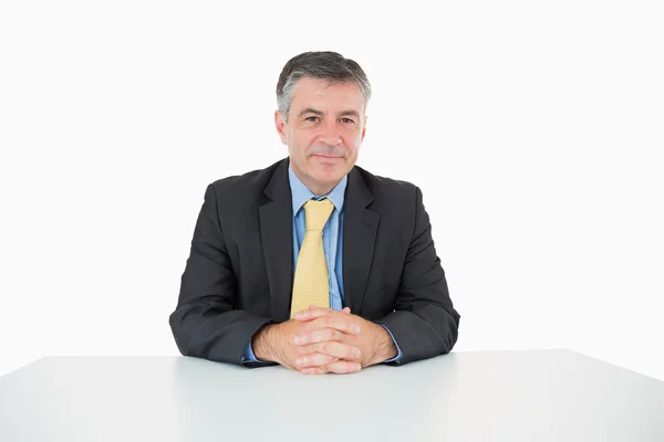 Well-dressed man sitting at his desk — Stock Photo, Image