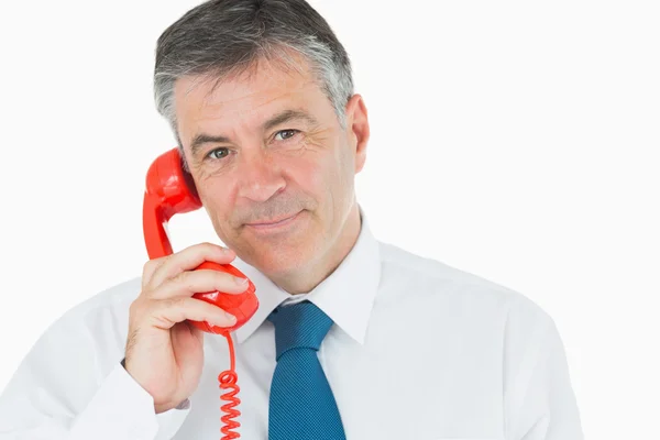 Businessman on red phone — Stock Photo, Image