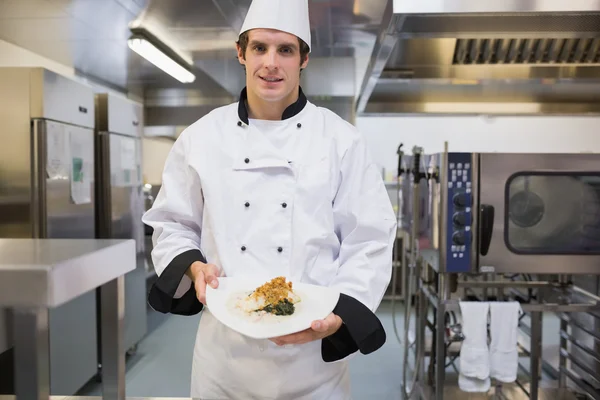 Cheerful chef presenting his plate — Stock Photo, Image