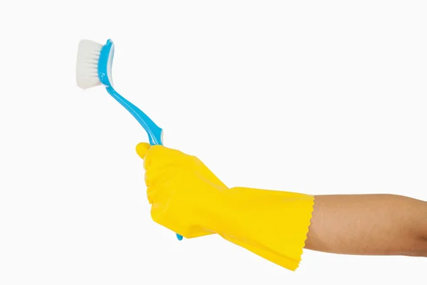 Woman's hand holding scrubbing brush — Stock Photo, Image