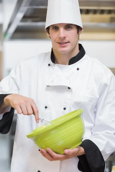 Smiling chef mixing with whisk — Stock Photo, Image
