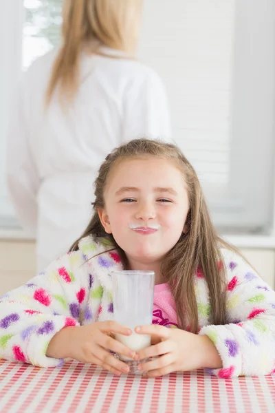 Little girl with milk moustache — Stock Photo, Image