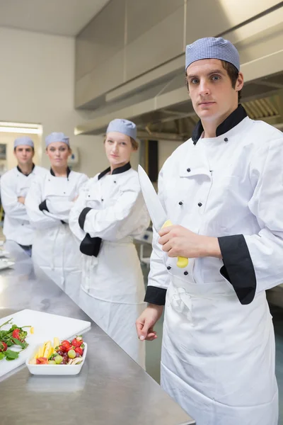 Chef looking stern holding a knife — Stock Photo, Image