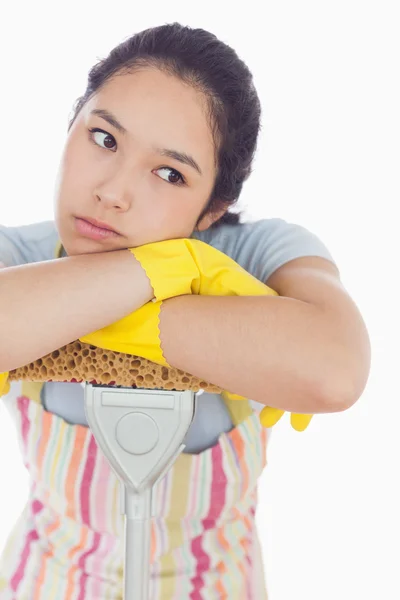 Fed up woman leaning on the mop — Stock Photo, Image