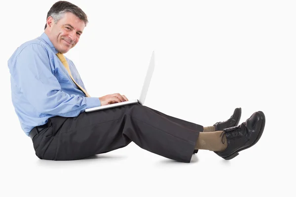 Happy man working with laptop on the floor — Stock Photo, Image