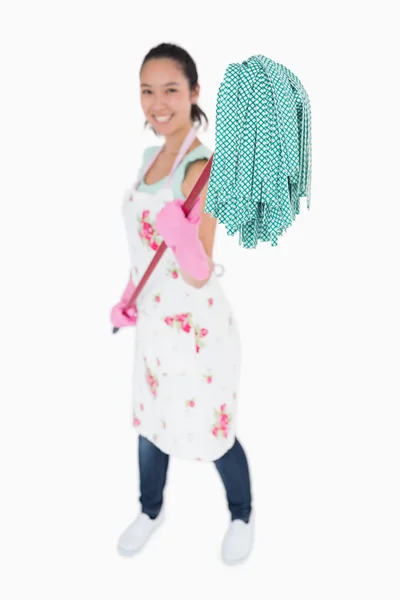 Woman holding a mop with gloves on — Stock Photo, Image