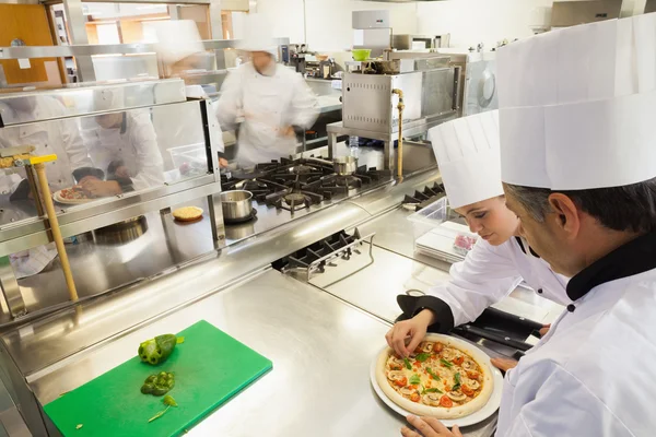 Cooks preparing pizza — Stock Photo, Image