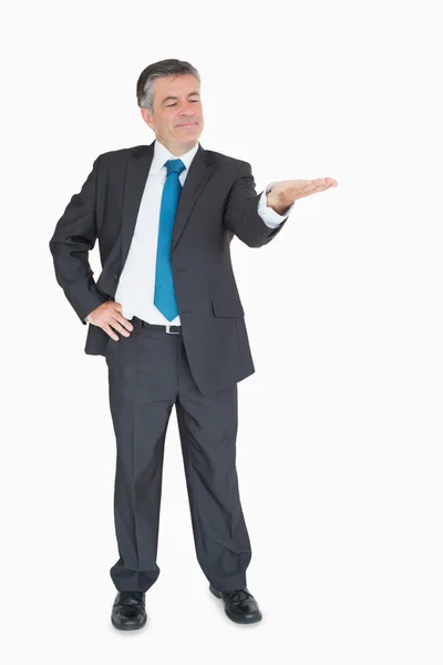 Businessman holding out hand — Stock Photo, Image