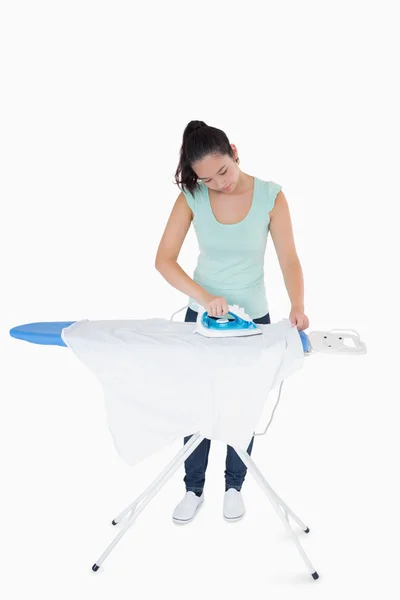 Brunette ironing shirts — Stock Photo, Image