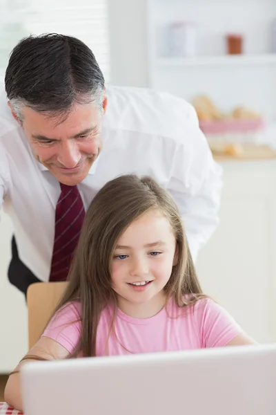 Father and child looking at a laptop — Stock Photo, Image