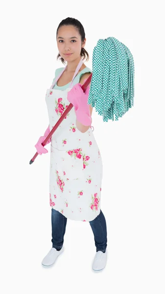 Woman holding a mop in the air — Stock Photo, Image