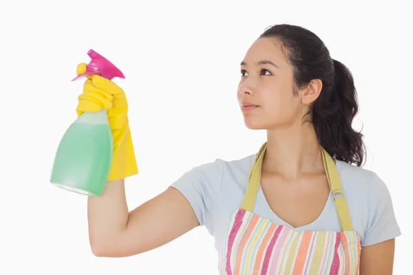 Young woman spraying cleaner — Stock Photo, Image