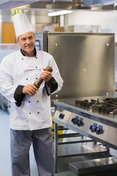Smiling chef holding a pepper mill — Stock Photo, Image