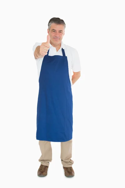 Man in apron giving thumbs up — Stock Photo, Image