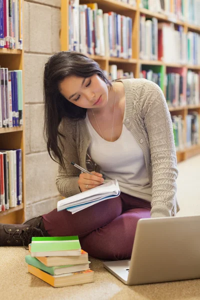 Student working on the library floor Stock Photo