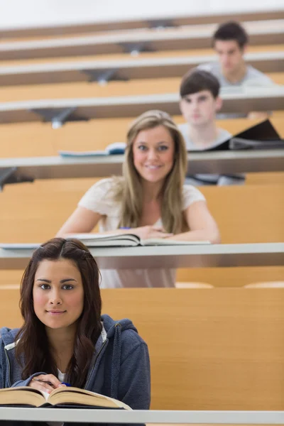 Students sitting looking and smiling Royalty Free Stock Photos