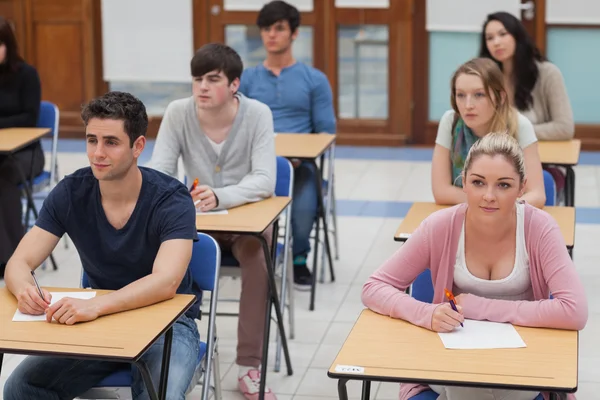 Students sitting in the exam room Stock Photo