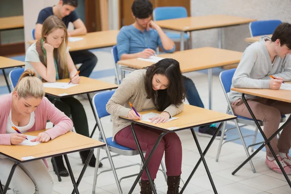 Students writing in the exam hall Royalty Free Stock Photos
