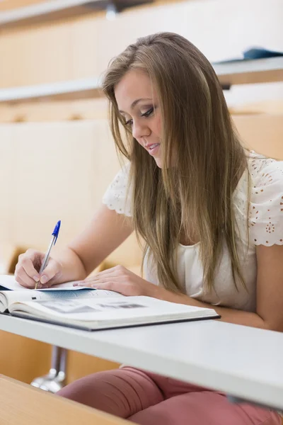 Focused student sitting at the lecture hall Stock Image