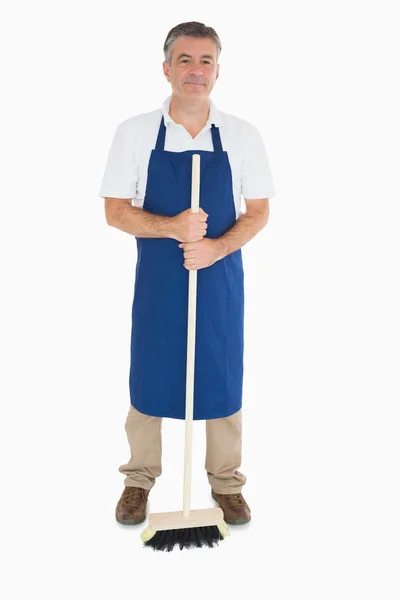 Man in apron with brush — Stock Photo, Image