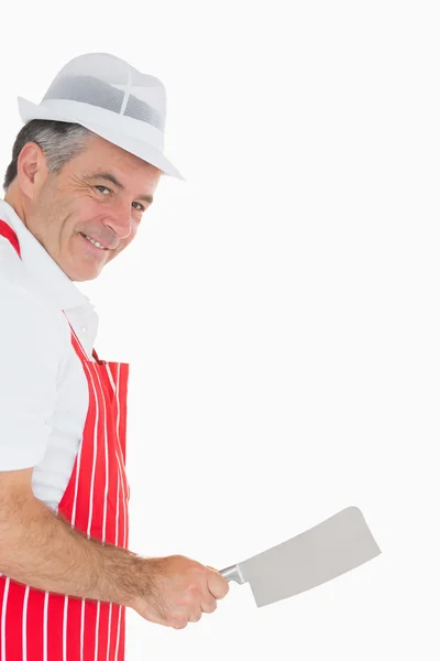 Butcher wielding meat cleaver and smiling — Stock Photo, Image