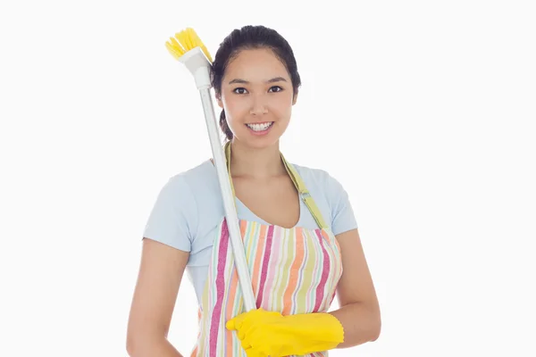 Happy woman with a broom on her shoulder — Stock Photo, Image