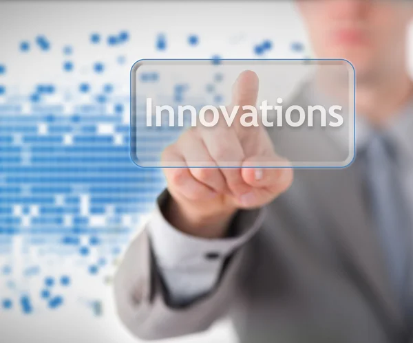 Businessman standing while pointing to the word innovation — Stock Photo, Image