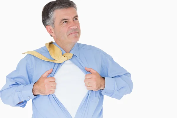 Serious man pulling his shirt with his hands — Stock Photo, Image