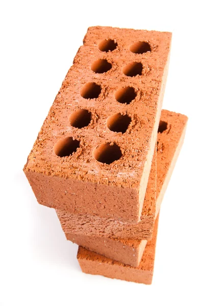 Four clay bricks being stacked — Stock Photo, Image