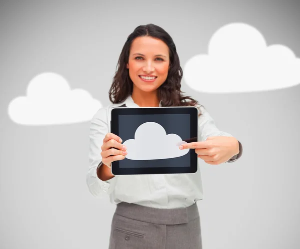 Businesswoman holding a tablet pc showing cloud symbol — Stock Photo, Image
