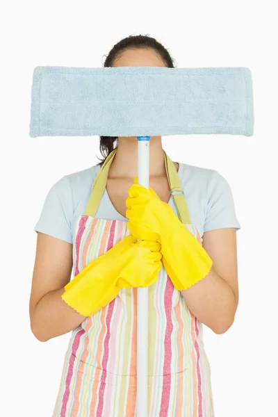 Young woman hiding behind mop — Stock Photo, Image