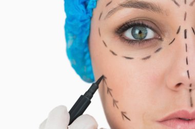 Plastic surgeon marking face clipart