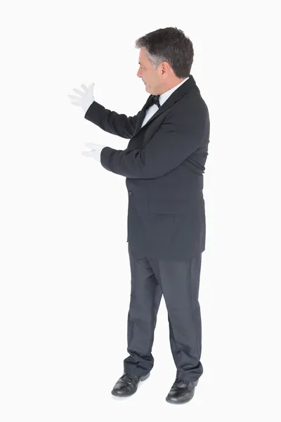 Waiter showing something to the left — Stock Photo, Image