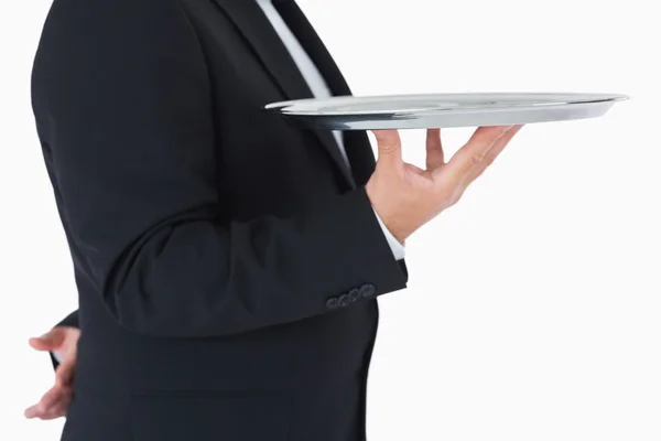 Waiter standing and holding a silver tray — Stock Photo, Image