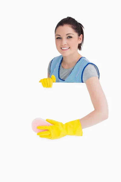 Cheerful maid washing with a sponge — Stock Photo, Image