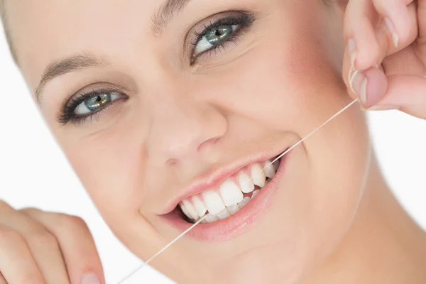 Woman using dental floss — Stock Photo, Image