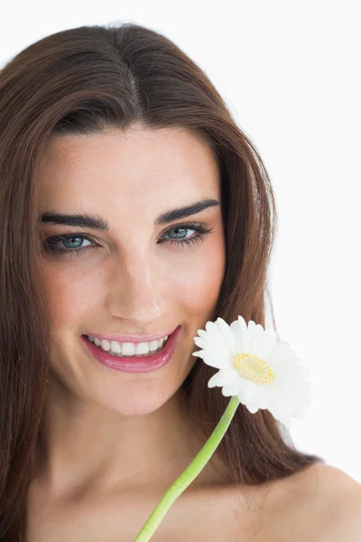 Smiling female beauty holding a flower — Stock Photo, Image