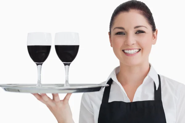 Happy waitress holding two glass of wine — Stock Photo, Image