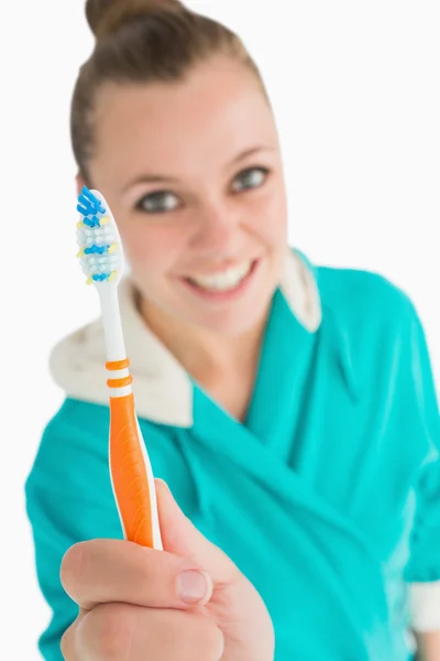 Woman with bathrobe showing her toothbrush — Stock Photo, Image