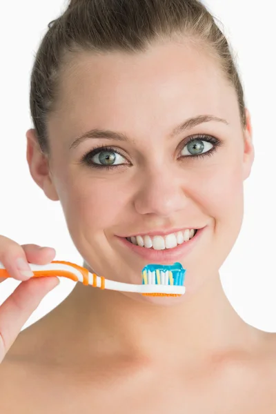 Smiling woman holding toothbrush — Stock Photo, Image