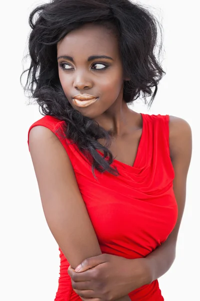 Woman standing while wearing a red dress — Stock Photo, Image