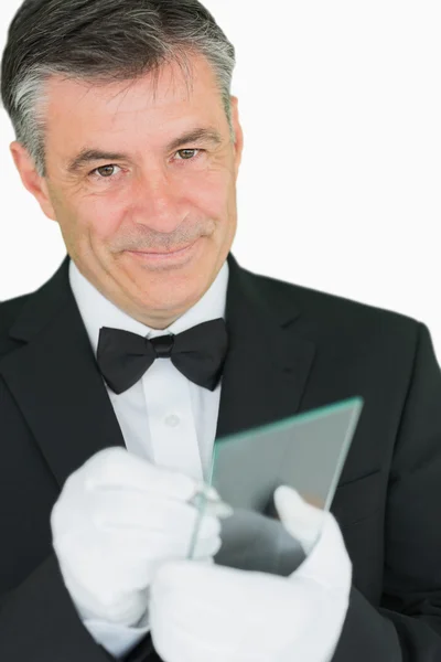 Happy waiter writing on virtual screen — Stock Photo, Image