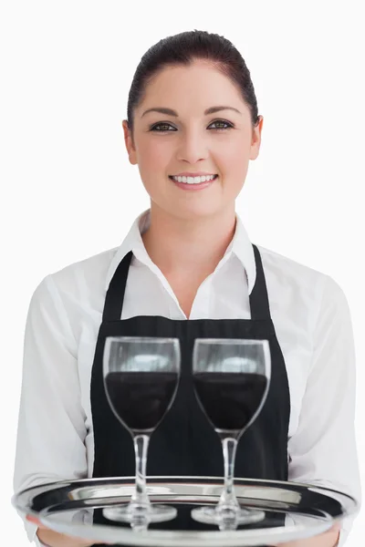 Smiling waitress holding two glasses of wine — Stock Photo, Image