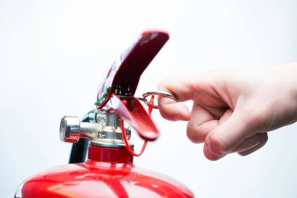 Pulling pin of fire extinguisher — Stock Photo, Image