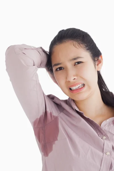 Woman appalled by her sweat patches — Stock Photo, Image