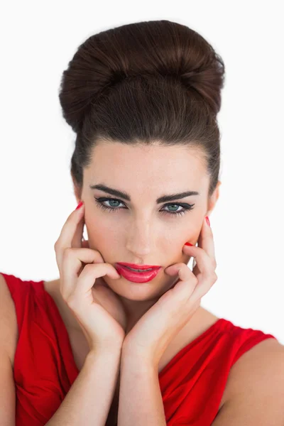 Woman touching her face and looking serious — Stock Photo, Image