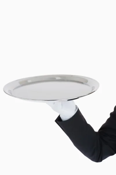 White gloved hand holding a silver tray — Stock Photo, Image