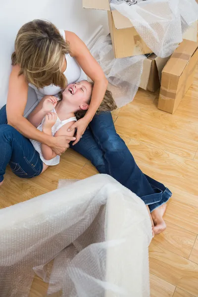 Mother tickling her daughter — Stock Photo, Image