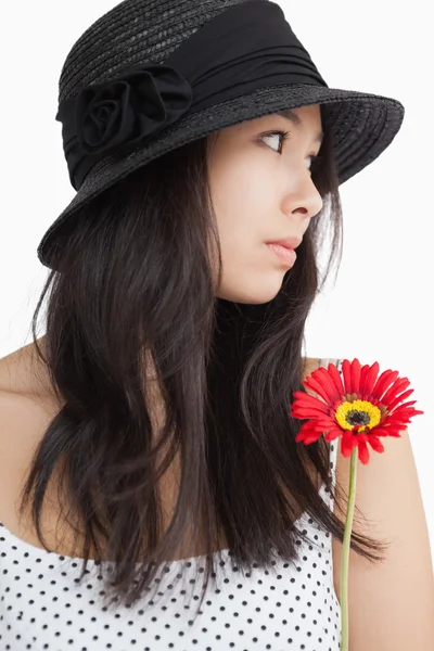 Woman with flower looking away — Stock Photo, Image