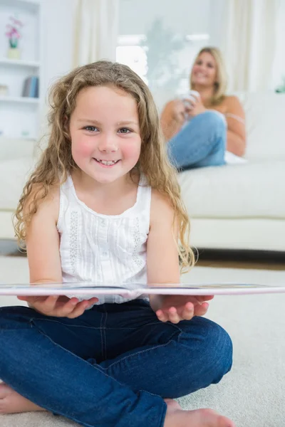 Laughing daughter with a book — Stock Photo, Image